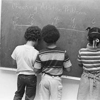 B2 198305040016 3 students at board.jpg